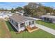 An aerial view of a charming single-story home featuring a well-manicured lawn and private driveway at 14311 Action St, Brooksville, FL 34613