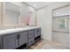 Stylish bathroom features a double vanity with modern fixtures and a tiled backsplash at 14311 Action St, Brooksville, FL 34613
