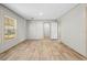 Spacious bedroom features wood-look floors, a large window, and a walk-in closet at 14311 Action St, Brooksville, FL 34613