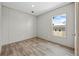 Cozy bedroom with wood-look flooring and a window overlooking the outdoors at 14311 Action St, Brooksville, FL 34613