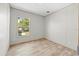 Bright bedroom with wood-look flooring and a window offering natural light at 14311 Action St, Brooksville, FL 34613