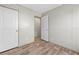 Bedroom featuring wood-look floors, closet space, and neutral wall colors at 14311 Action St, Brooksville, FL 34613