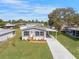 Charming home featuring a covered carport, landscaped yard, and a welcoming entrance at 14311 Action St, Brooksville, FL 34613