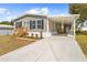 Inviting single-story home with a covered carport, landscaping, and a well-maintained driveway at 14311 Action St, Brooksville, FL 34613