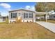 Beautiful single-story home with landscaped front yard, carport, and inviting entryway at 14311 Action St, Brooksville, FL 34613