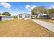 Charming single-story home featuring a well-manicured lawn and a private driveway at 14311 Action St, Brooksville, FL 34613