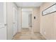 Bright hallway featuring wood-look floors and neutral wall colors at 14311 Action St, Brooksville, FL 34613
