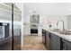 Modern kitchen featuring stainless steel appliances, white cabinetry, and wood flooring at 14311 Action St, Brooksville, FL 34613