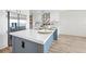 Stylish kitchen island with a white countertop, sink, and stainless steel appliances at 14311 Action St, Brooksville, FL 34613