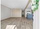 Spacious living room flowing into a modern kitchen with an island and wood-style floors at 14311 Action St, Brooksville, FL 34613