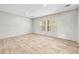 Spacious living room with wood-look flooring and large windows at 14311 Action St, Brooksville, FL 34613