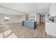 Open-concept living space with wood flooring, white walls, and a blue kitchen island at 14311 Action St, Brooksville, FL 34613