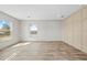 Neutral room featuring wood-look flooring, light walls, and natural light from windows at 14311 Action St, Brooksville, FL 34613