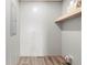 Storage room features wood-look flooring, light walls, and a wood shelf at 14311 Action St, Brooksville, FL 34613