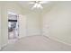 Bright bedroom featuring a ceiling fan, neutral walls, carpeted floors and a closet for storage at 15209 Hammock Chase Ct, Odessa, FL 33556