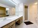 Bathroom featuring double sinks, a walk-in shower, and tile flooring at 1526 King Dr # 1526, Dunedin, FL 34698