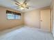 Comfortable bedroom with ceiling fan, window, and access to an ensuite bathroom at 1526 King Dr # 1526, Dunedin, FL 34698