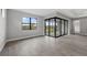 Bright living room featuring tile floors, large windows, and sliding glass doors leading to a screened patio at 1829 Pepper Grass Dr, North Port, FL 34289