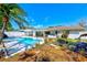 An overview of the backyard area featuring a sparkling pool and spa at 1831 Kay Dr, Largo, FL 33770