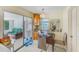 Cozy dining area with mirrored wall, adjacent to sun room with comfortable seating at 1831 Kay Dr, Largo, FL 33770