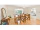 Bright dining area with wood floors, view of the pool and backyard, and comfortable seating at 1831 Kay Dr, Largo, FL 33770