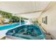 Relaxing hot tub next to the pool and covered patio for year-round enjoyment at 1831 Kay Dr, Largo, FL 33770