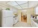 Kitchen features white cabinets, functional appliances and connection to the dining room at 1831 Kay Dr, Largo, FL 33770