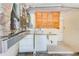 Functional laundry area features a washing machine, dryer, sink, cabinetry, and utility connections at 1831 Kay Dr, Largo, FL 33770