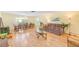 Spacious living room with wood floors, dining area, and comfortable seating arrangement at 1831 Kay Dr, Largo, FL 33770