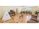 Open-concept living room with wood floors, neutral walls, and ample natural light from the windows at 1831 Kay Dr, Largo, FL 33770