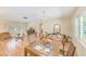 Open living space with wood floors that connects the living and dining areas, offering a view of the yard at 1831 Kay Dr, Largo, FL 33770