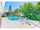 Refreshing backyard swimming pool surrounded by tropical landscaping offering a private oasis for relaxation and enjoyment at 1831 Kay Dr, Largo, FL 33770