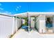 Pool area with lounge furniture, inflatable rings, and white privacy fence, providing a fun space for relaxation and recreation at 1831 Kay Dr, Largo, FL 33770