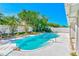 Sparkling pool in a private backyard oasis with lush landscaping and serene ambiance at 1831 Kay Dr, Largo, FL 33770