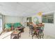 Bright sunroom with comfortable seating, table, and outdoor views, perfect for relaxation and entertaining at 1831 Kay Dr, Largo, FL 33770