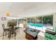 Inviting sunroom with furniture providing seamless indoor-outdoor flow to the sparkling pool area at 1831 Kay Dr, Largo, FL 33770