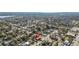 Aerial shot showing the home surrounded by lush trees and suburban neighborhood near a large body of water at 1900 17Th S St, St Petersburg, FL 33712