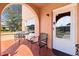 Outdoor chairs and tables line a beautiful covered peach colored front porch at 1900 17Th S St, St Petersburg, FL 33712
