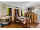 Dining room with decorative curtains, and wood flooring, adjacent to the living room at 1900 17Th S St, St Petersburg, FL 33712