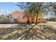 View of the house with a fence on the side and a large tree in the yard at 1900 17Th S St, St Petersburg, FL 33712