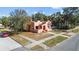A charming, peach-colored house surrounded by mature trees in a residential neighborhood at 1900 17Th S St, St Petersburg, FL 33712