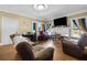 Cozy living room showcasing ample seating, wood floors, and neutral wall tones at 1900 17Th S St, St Petersburg, FL 33712