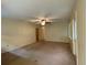 Spacious living room featuring a ceiling fan and neutral carpeting at 1904 N Cross St, Plant City, FL 33563