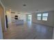 Open-concept living area with tile flooring seamlessly connects to a modern kitchen, perfect for entertaining guests at 212 Lazy Shore Dr Dr, Nokomis, FL 34275