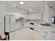 Bright kitchen with modern white appliances and ample counter space at 2503 New Haven Cir, Sun City Center, FL 33573