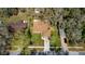 An aerial view of a residential home featuring mature trees and a lush green lawn at 2503 Withy Ct, Tampa, FL 33618