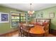 Traditional dining room with green walls, wood table, and large window at 2503 Withy Ct, Tampa, FL 33618