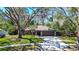 Charming single-story home with a large tree and a two-car garage at 2504 Woodcote Ter, Palm Harbor, FL 34685