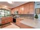 Stylish kitchen with stainless steel oven, granite counters, and backsplash at 2504 Woodcote Ter, Palm Harbor, FL 34685