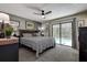 Cozy main bedroom with a ceiling fan, sliding glass door, and view of the pool area at 2504 Woodcote Ter, Palm Harbor, FL 34685